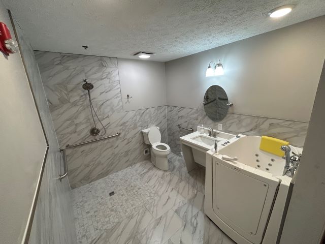 Modern and accessible bathroom with marble finish at Lighthouse PCH.