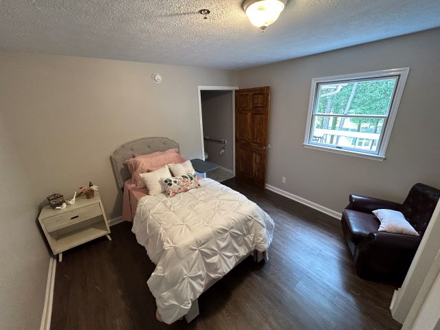 Elegantly furnished private bedroom at Lighthouse PCH with a serene view.