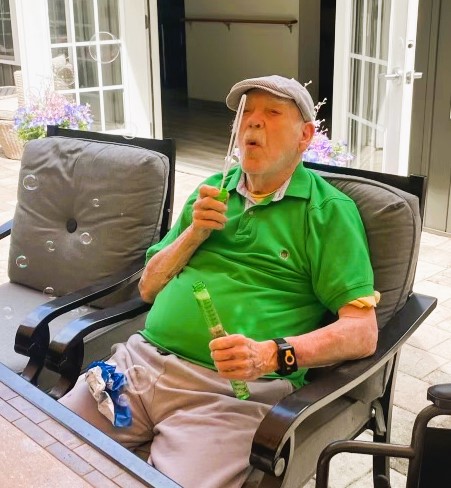 fun-activity Gentleman blowing bubbles at personal care home